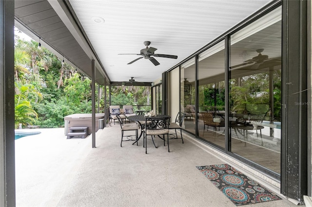 view of patio with a swimming pool with hot tub and ceiling fan