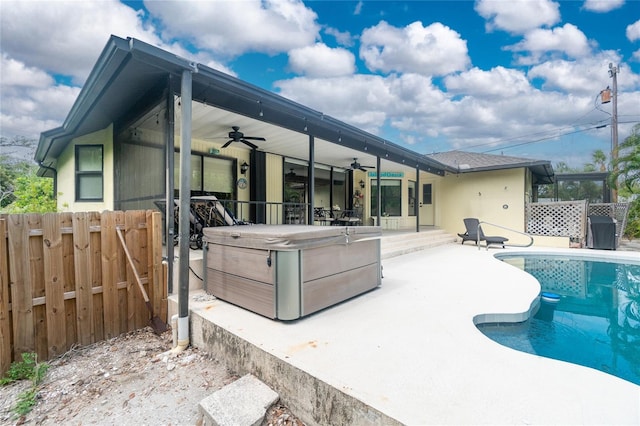 exterior space with a hot tub, ceiling fan, and a patio area