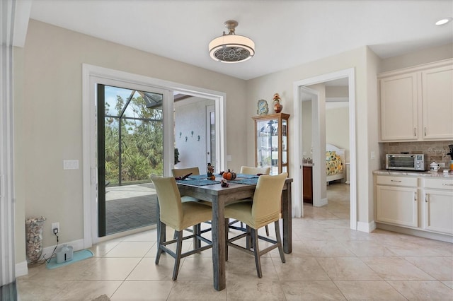 12194 Everglades Ave, Port Charlotte, FL 33981 - dining space featuring baseboards and light tile patterned flooring