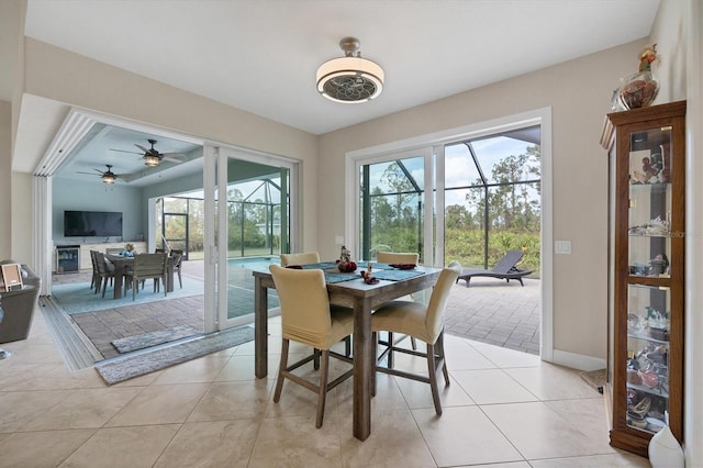 dining space featuring light tile patterned floors and ceiling fan