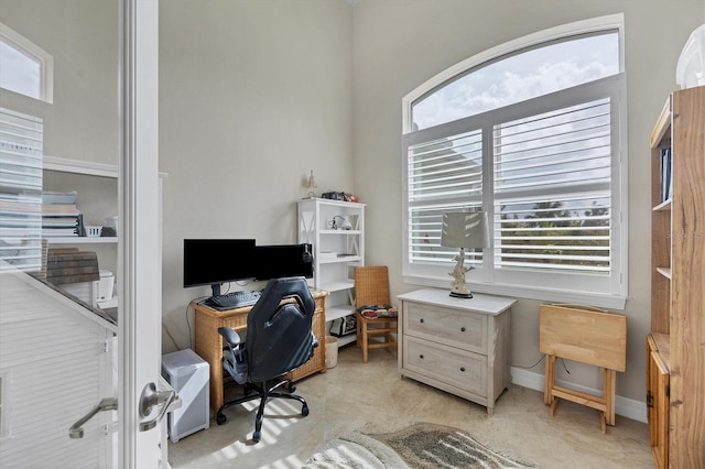 office space with a wealth of natural light and light carpet