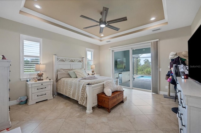 tiled bedroom featuring ceiling fan, ornamental molding, a tray ceiling, and access to outside