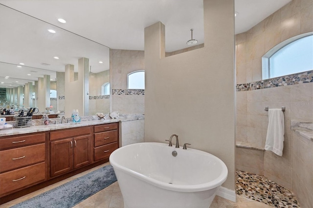 bathroom featuring vanity, tile patterned floors, separate shower and tub, and tile walls