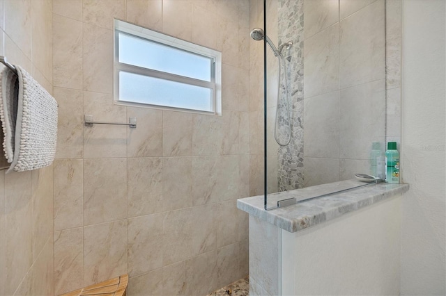 bathroom with a tile shower