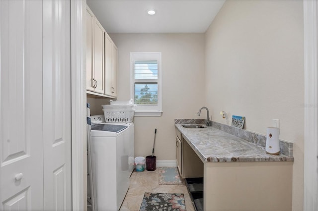 clothes washing area featuring washer and clothes dryer, cabinets, sink, and light tile patterned floors