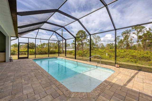 view of swimming pool with a patio area and a lanai