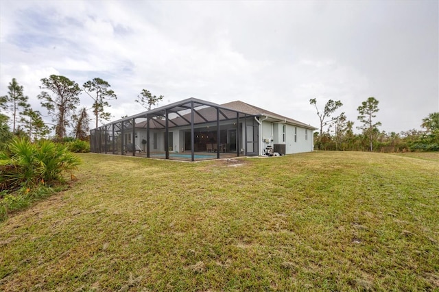12194 Everglades Ave, Port Charlotte, FL 33981 - rear view of property featuring a lawn, a lanai, an outdoor pool, and cooling unit