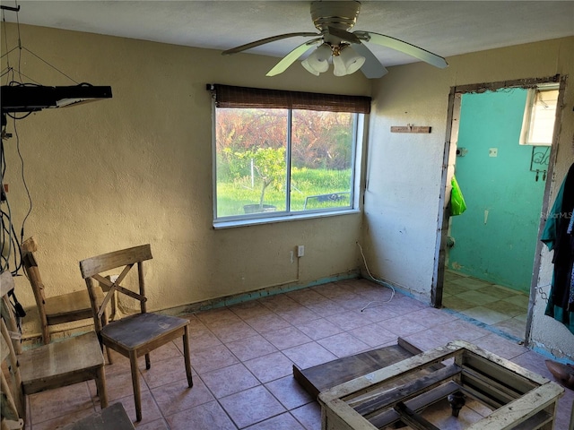 interior space with ceiling fan and light tile patterned flooring