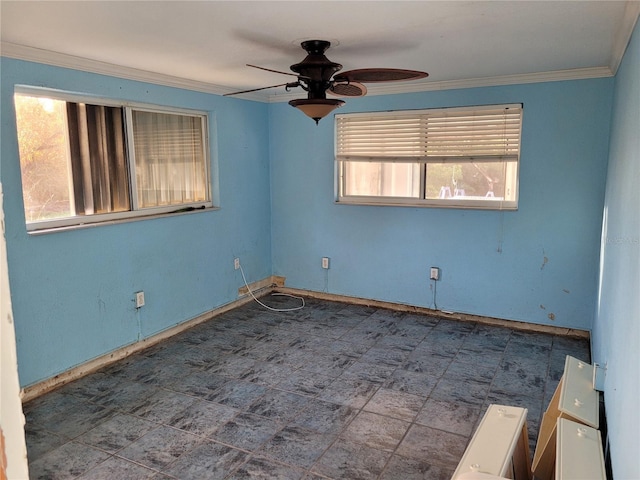 unfurnished room featuring ceiling fan and crown molding