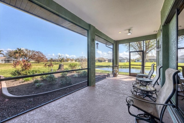 unfurnished sunroom with a water view