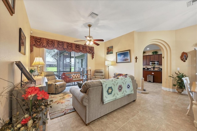 living room with light tile patterned flooring and ceiling fan