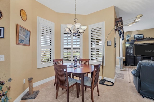 tiled dining area with an inviting chandelier