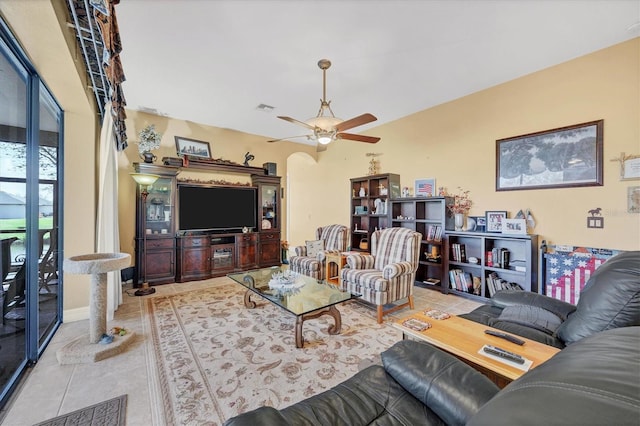 living room with ceiling fan and light tile patterned flooring