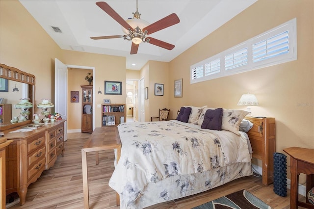 bedroom with light hardwood / wood-style flooring and ceiling fan