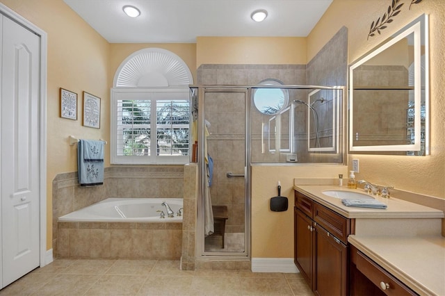 bathroom with tile patterned flooring, vanity, and independent shower and bath