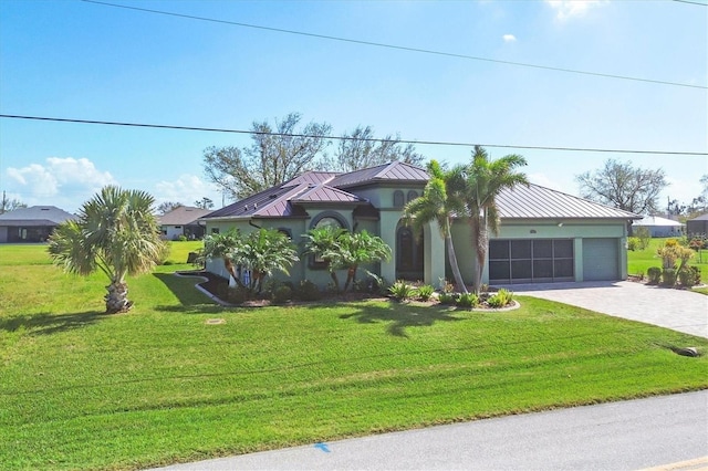 view of front of house with a garage and a front lawn