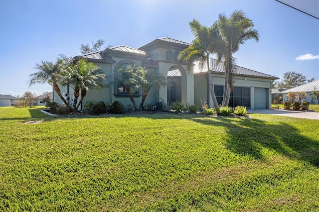 view of front of property with a front lawn and a garage