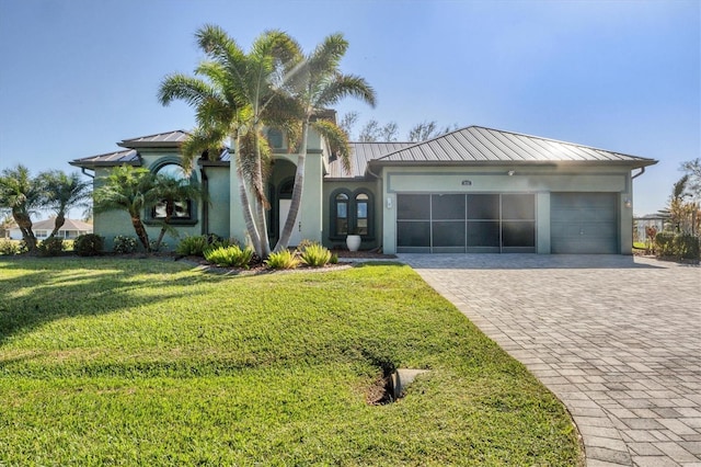 view of front of property featuring a garage and a front yard