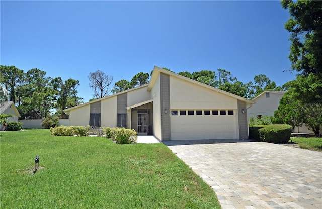 view of front of property featuring a garage and a front lawn