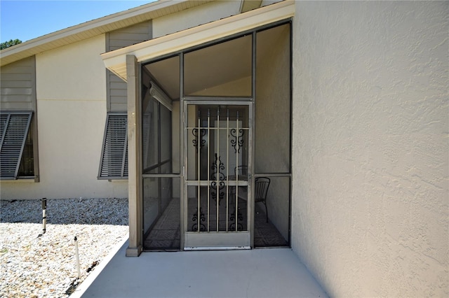 view of exterior entry featuring a patio area