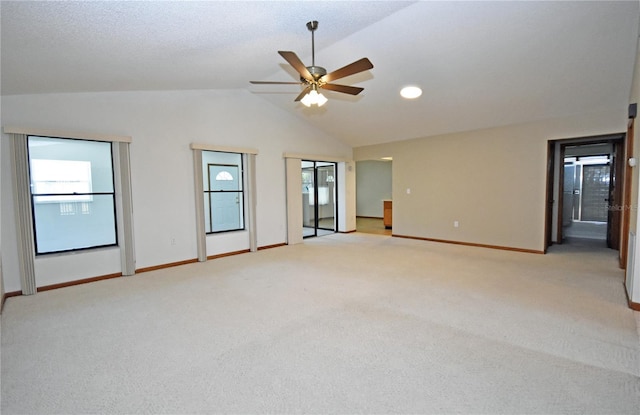 carpeted empty room with ceiling fan and lofted ceiling