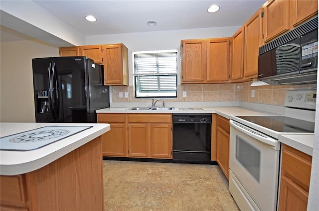 kitchen featuring sink, black appliances, and decorative backsplash