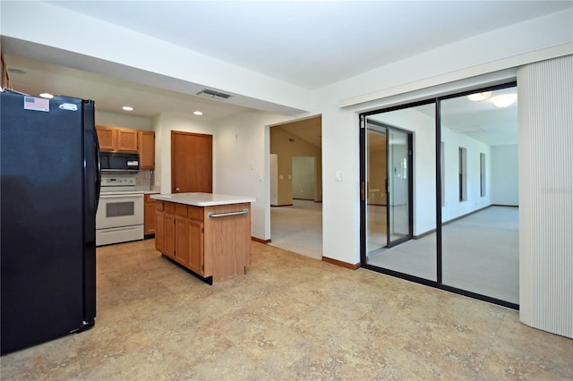 kitchen featuring black appliances and a center island