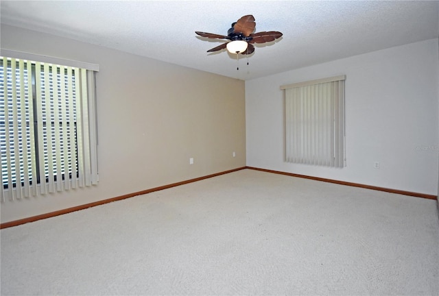 unfurnished room featuring carpet, a textured ceiling, and ceiling fan