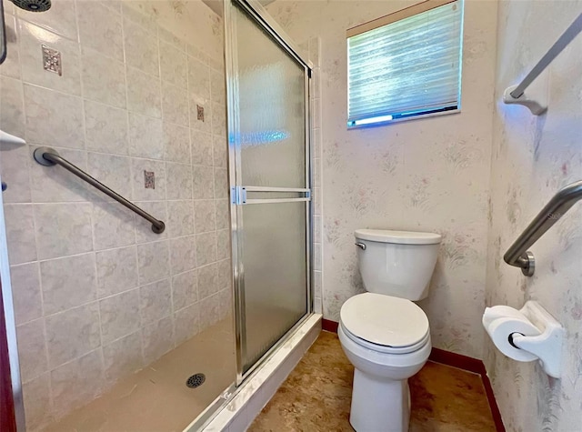 bathroom featuring toilet and an enclosed shower