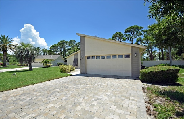 view of front of house featuring a garage and a front lawn