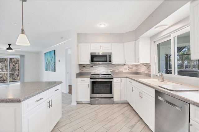 kitchen featuring appliances with stainless steel finishes, sink, and white cabinets