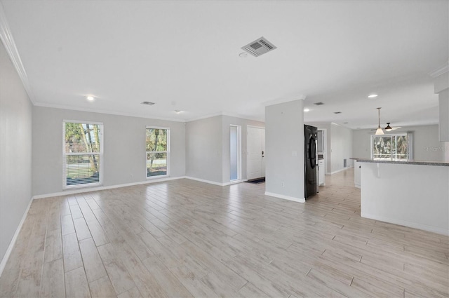 unfurnished living room with crown molding and light hardwood / wood-style floors