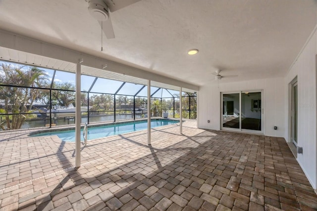 view of pool featuring a patio, a water view, and ceiling fan