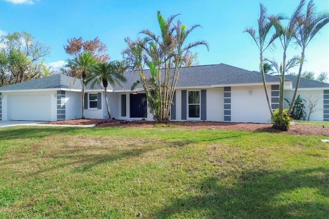 ranch-style home featuring a garage and a front lawn