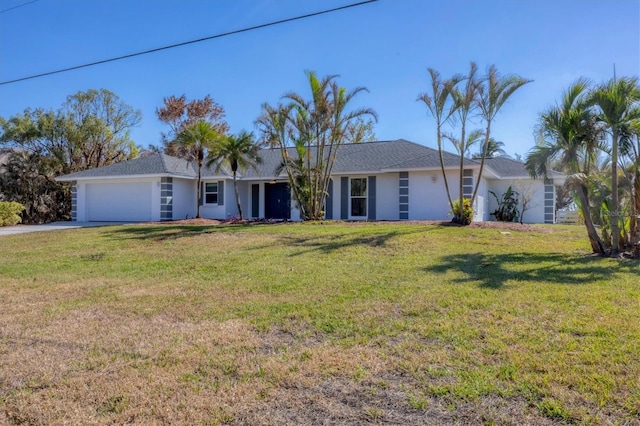 ranch-style house with a garage and a front lawn