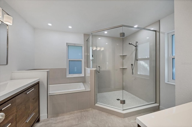 bathroom featuring vanity and separate shower and tub