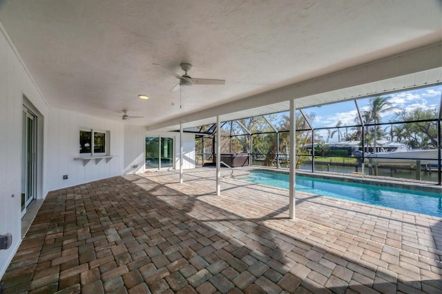 view of pool with a lanai, a patio, and ceiling fan