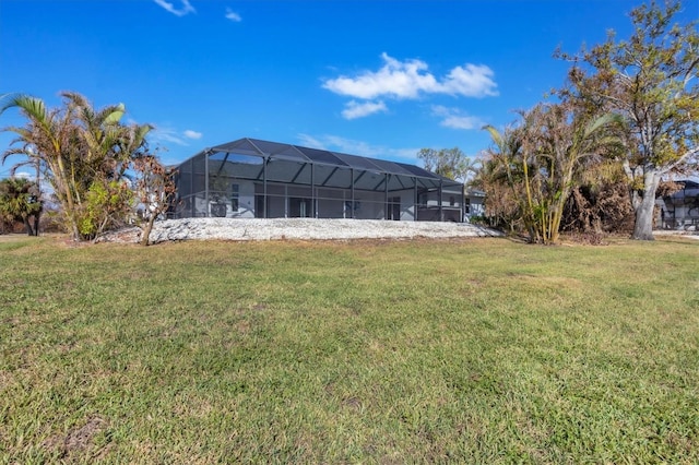 back of property with a yard and glass enclosure