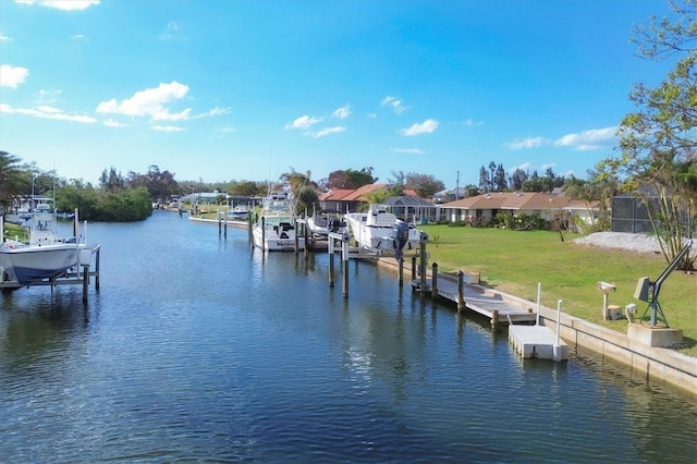 view of dock featuring a water view and a yard