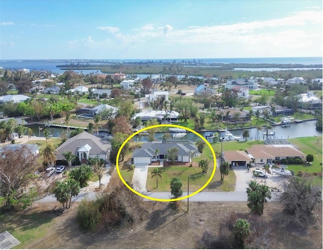 birds eye view of property with a water view