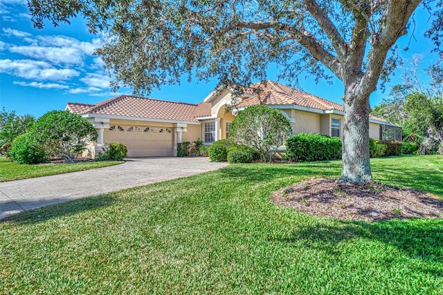 mediterranean / spanish-style home with a garage and a front yard