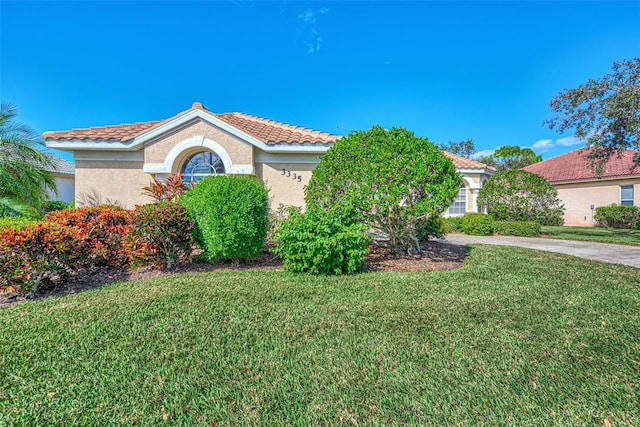 mediterranean / spanish-style home featuring a front lawn