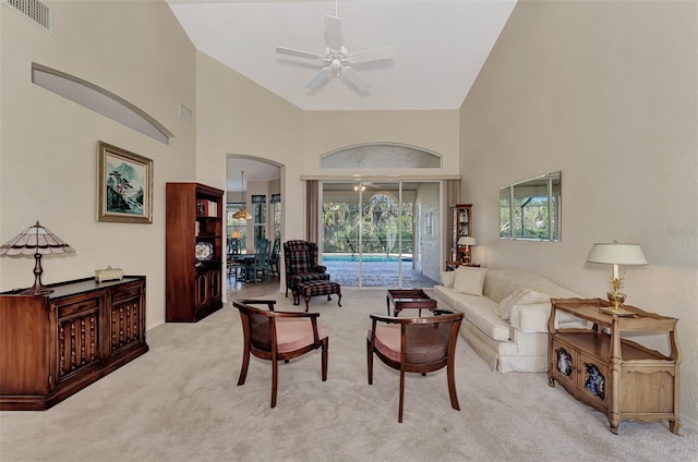 living room featuring ceiling fan, light colored carpet, and high vaulted ceiling