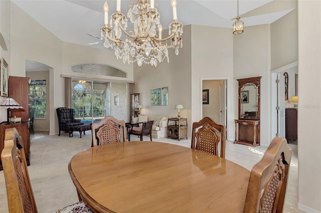 carpeted dining area featuring a towering ceiling