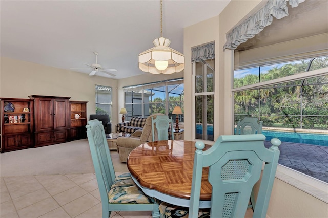 tiled dining space featuring ceiling fan