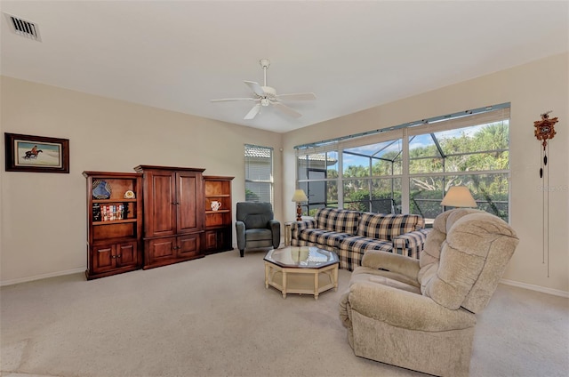 carpeted living room with ceiling fan