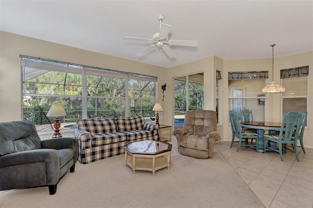 living room with a wealth of natural light, tile patterned flooring, and ceiling fan