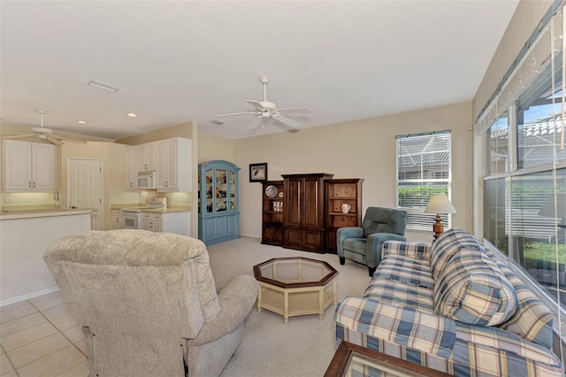 tiled living room featuring ceiling fan