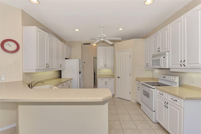 kitchen featuring light tile patterned flooring, white appliances, white cabinets, kitchen peninsula, and ceiling fan