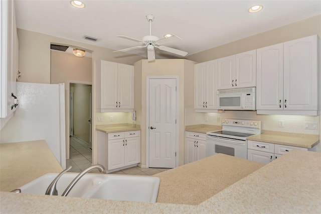 kitchen with white cabinets, sink, white appliances, and ceiling fan